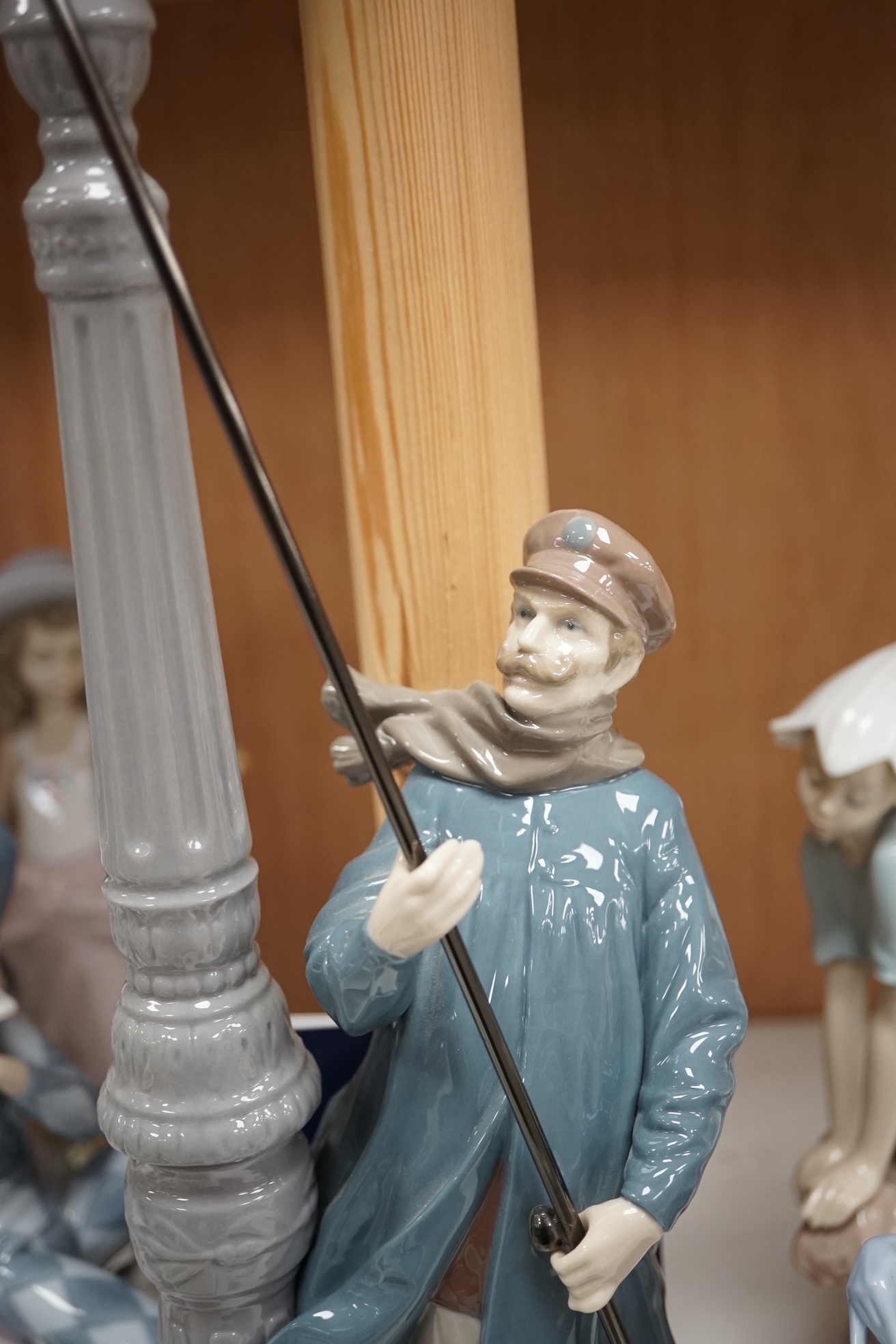 A group of Lladro figures to include ‘Lamplighter’ and ‘All aboard’, largest 48cm high. Condition - good